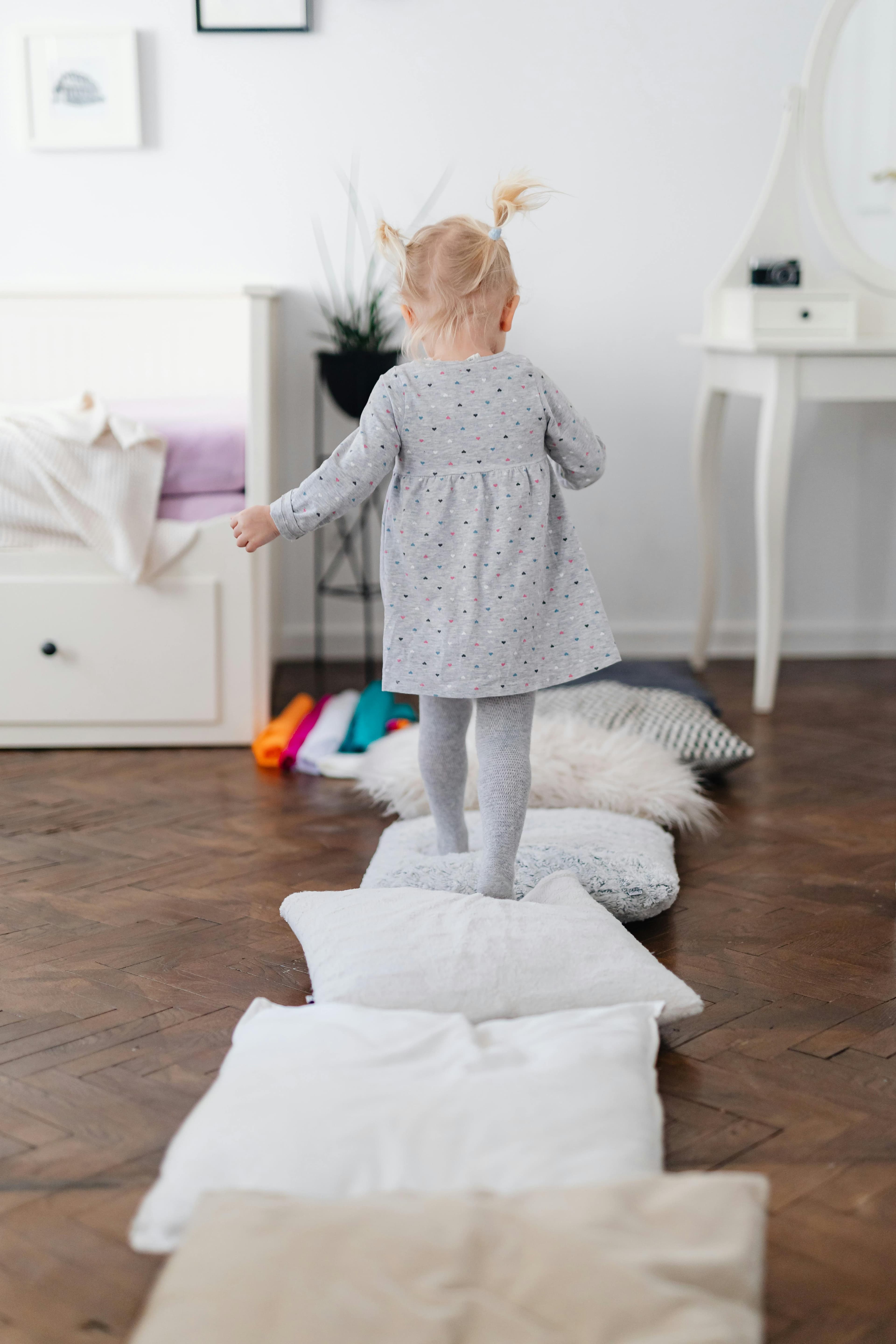 Pillow stepping-stone path laid out across a hardwood floor