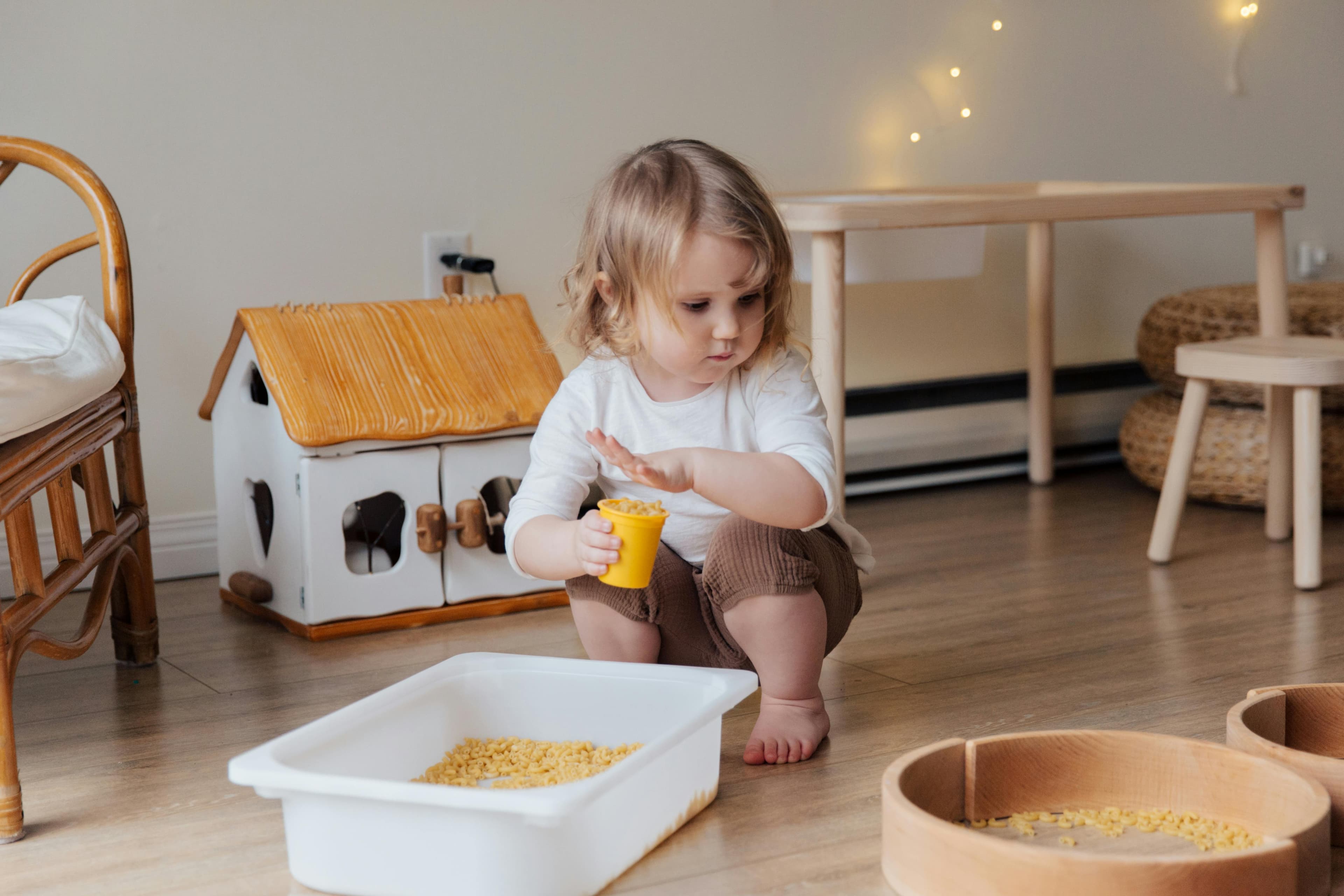 Clear under-bed storage tote with low sides for a sensory bin