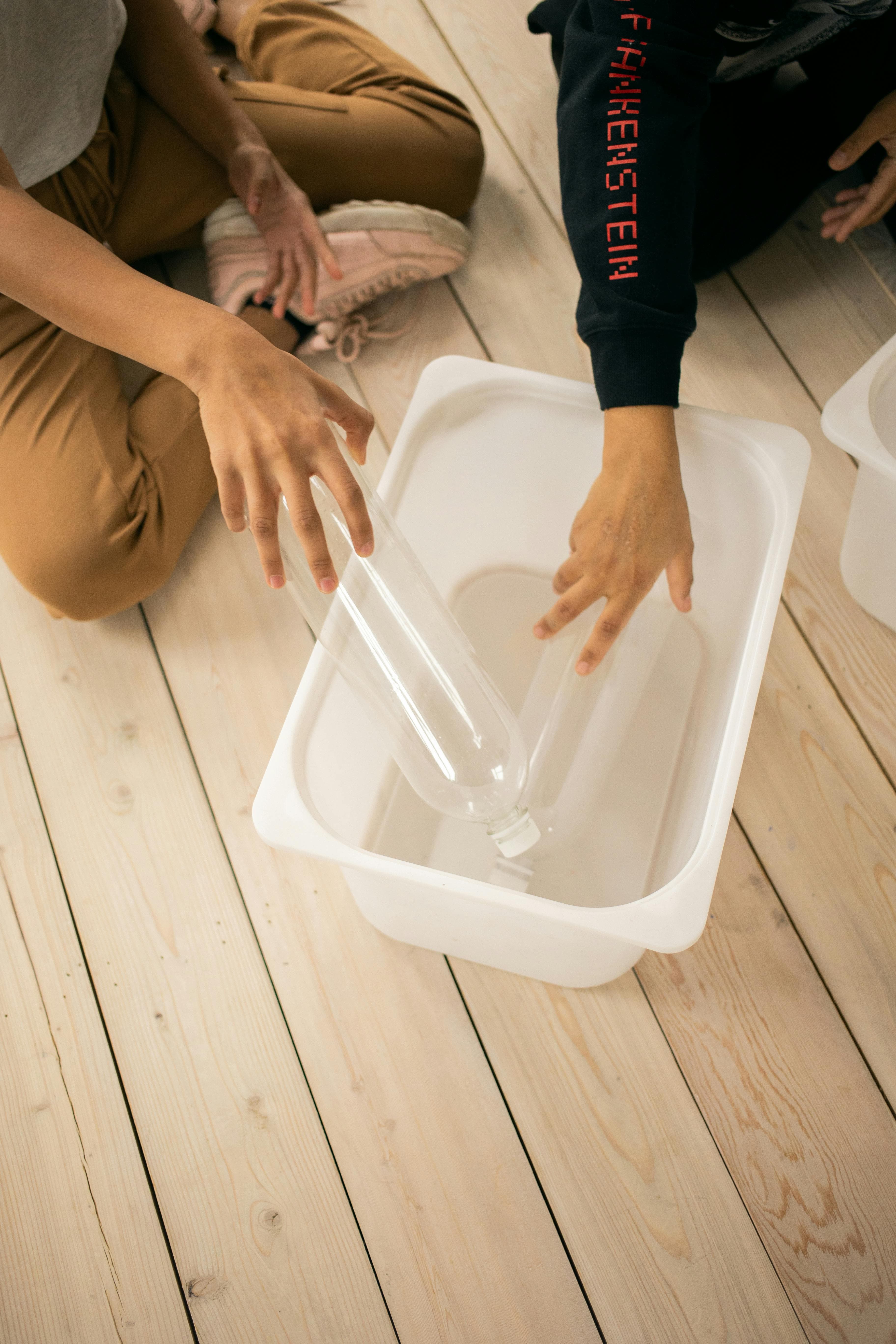 Paint stir sticks used as bridges in sensory bin highway play