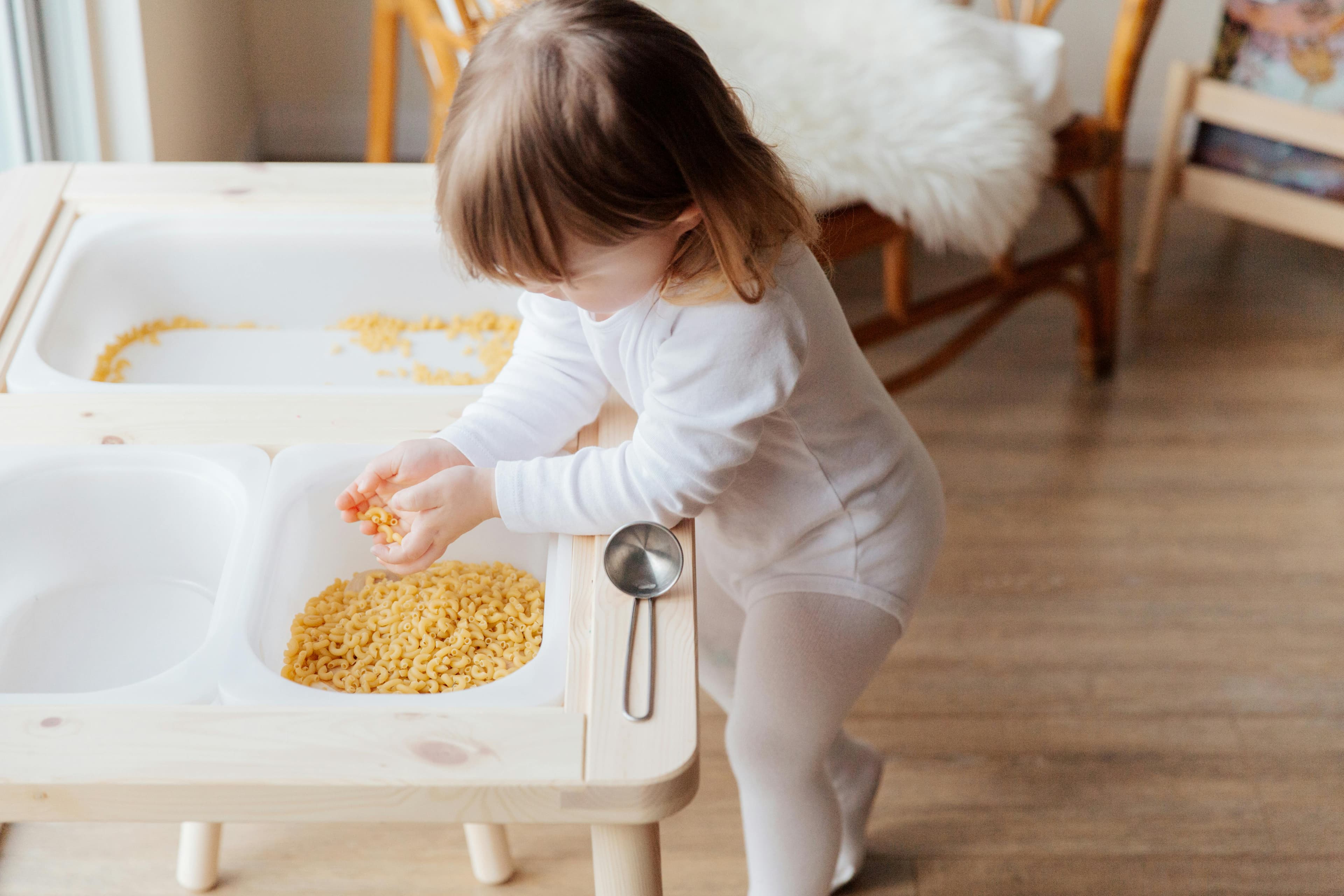 Pine bark or cedar chip base in a sensory bin