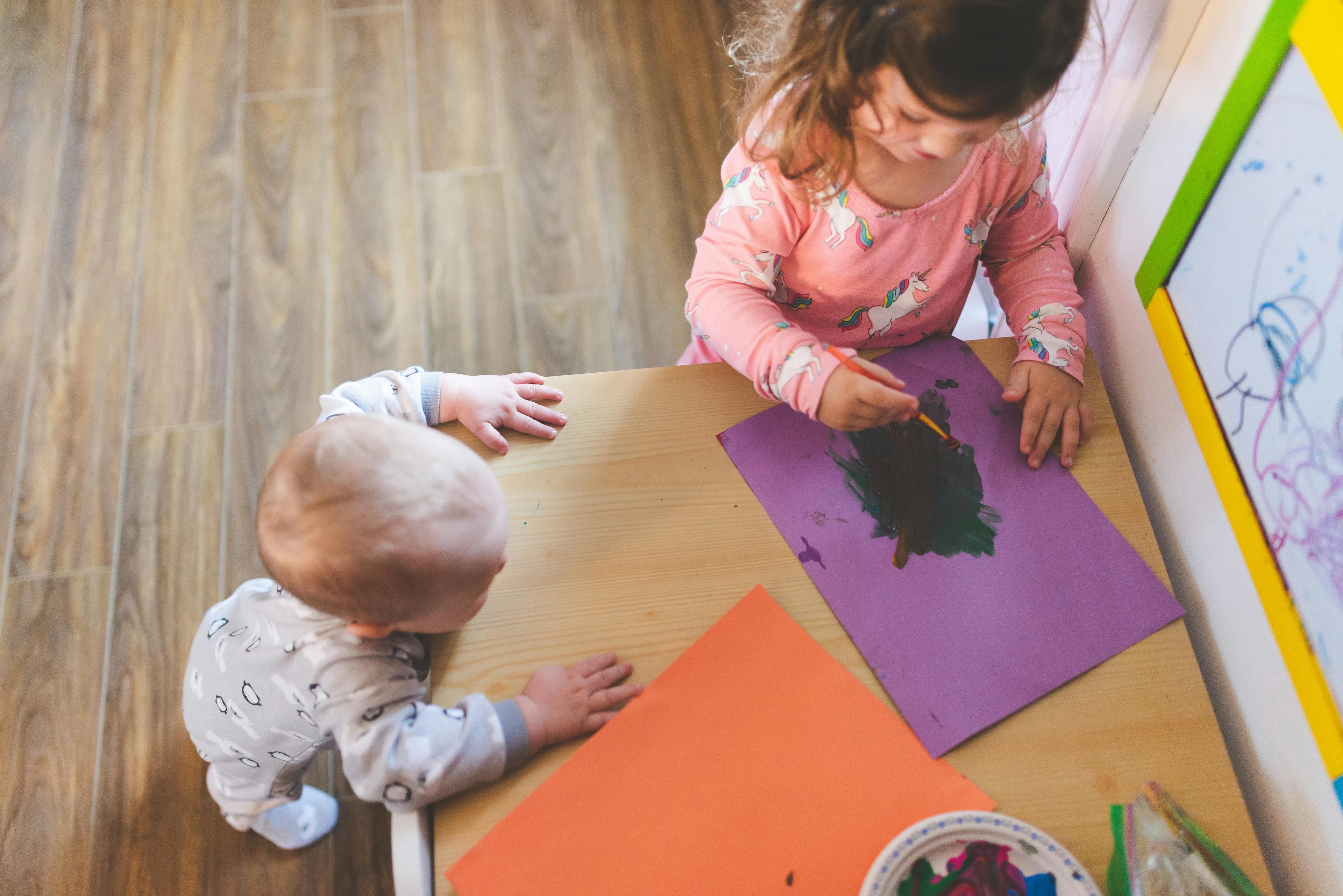 Child painting at a table during process art time